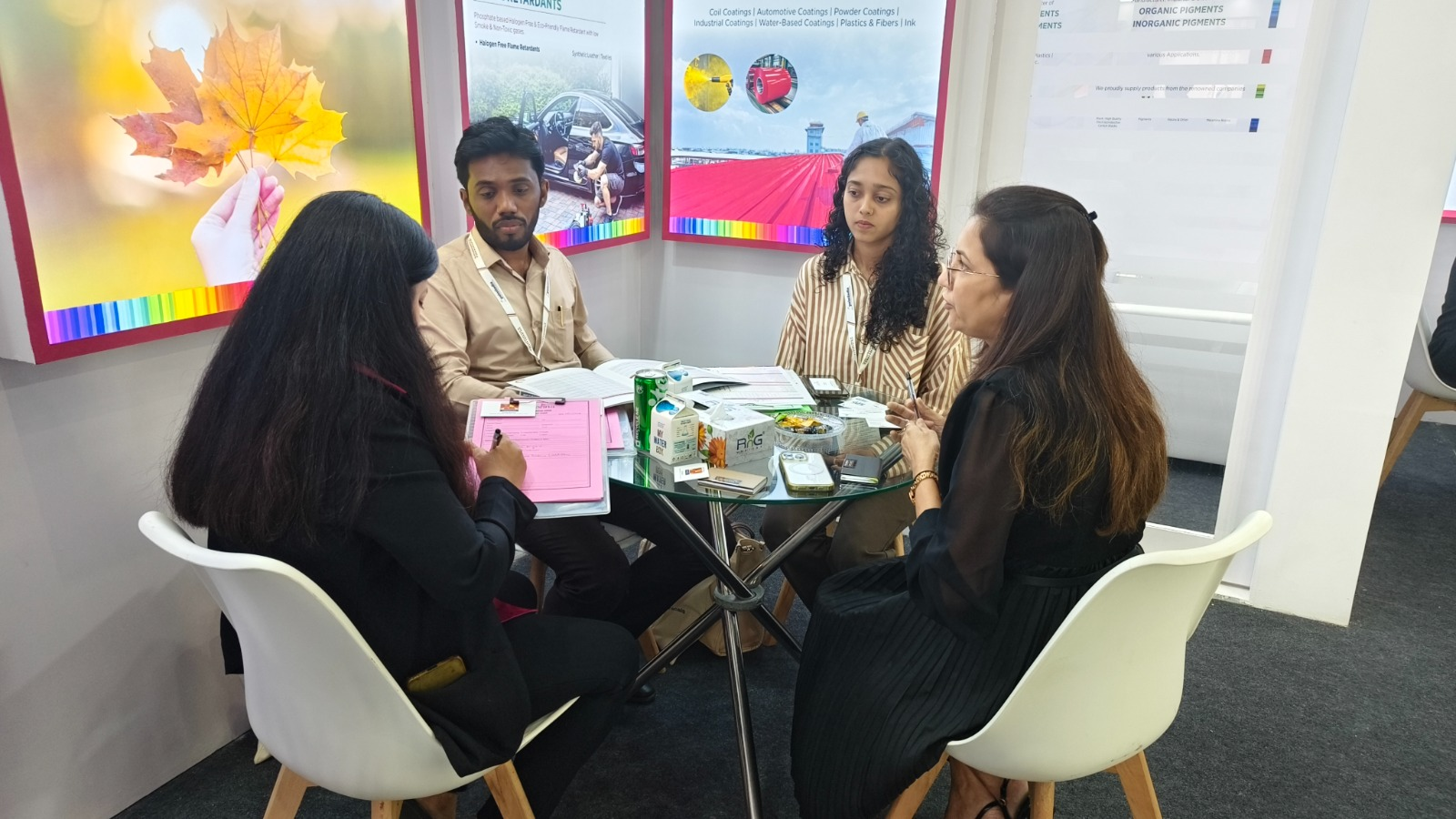 Colorina representatives holding a business meeting with clients at the trade show.