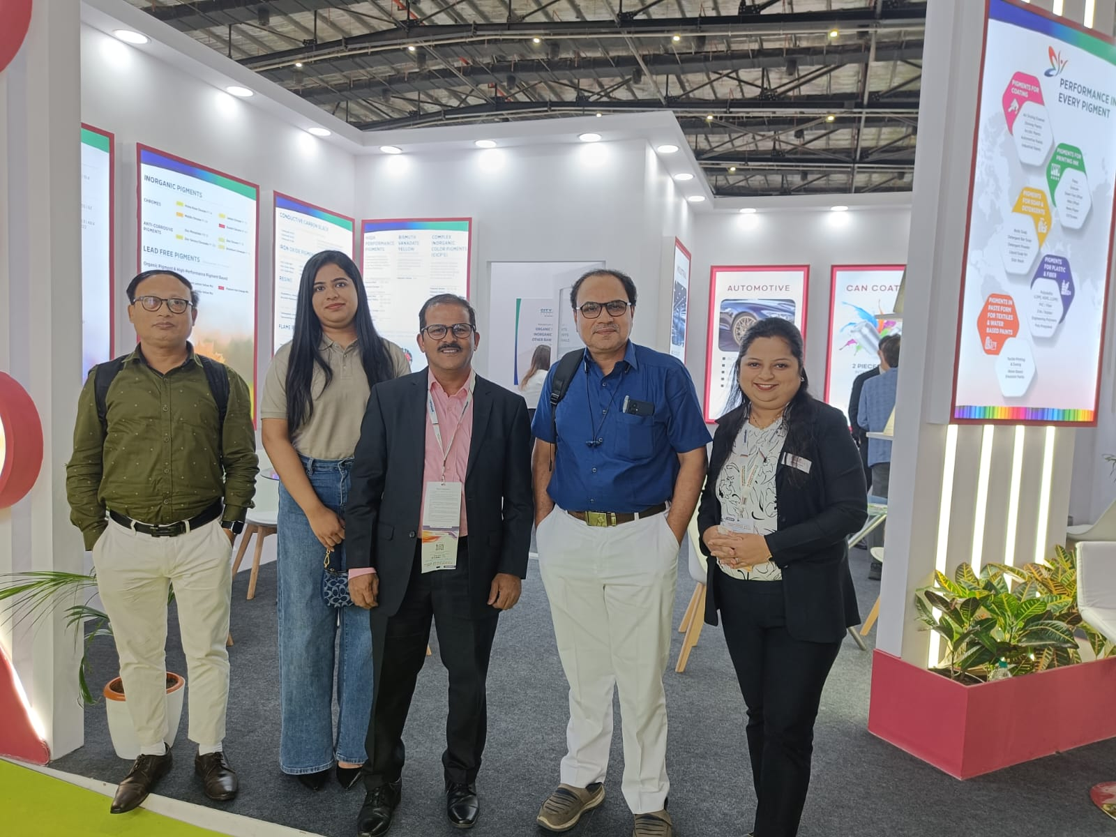 Colorina team members and industry delegates posing at the exhibition booth.