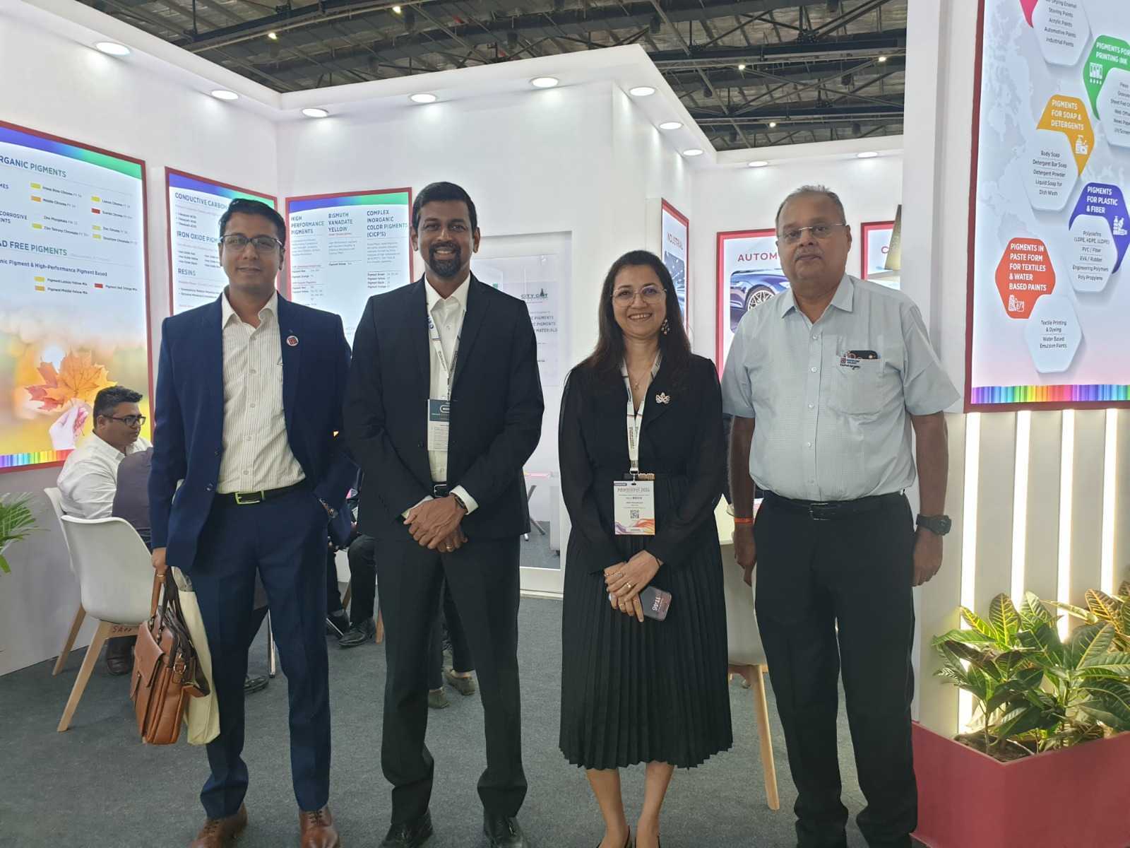 Colorina leadership and corporate business delegates gathered inside the chemical exhibition booth.